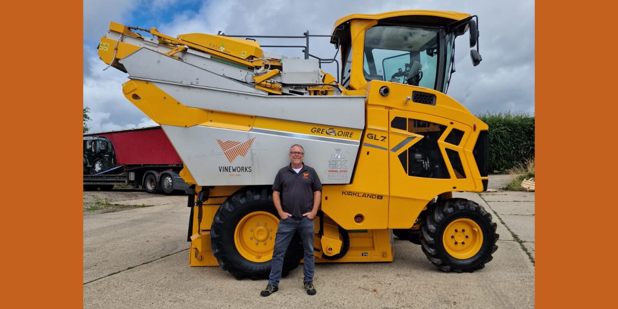 Photo of yellow Gregoire machine harvester with James Dodson CEO of VineWorks.