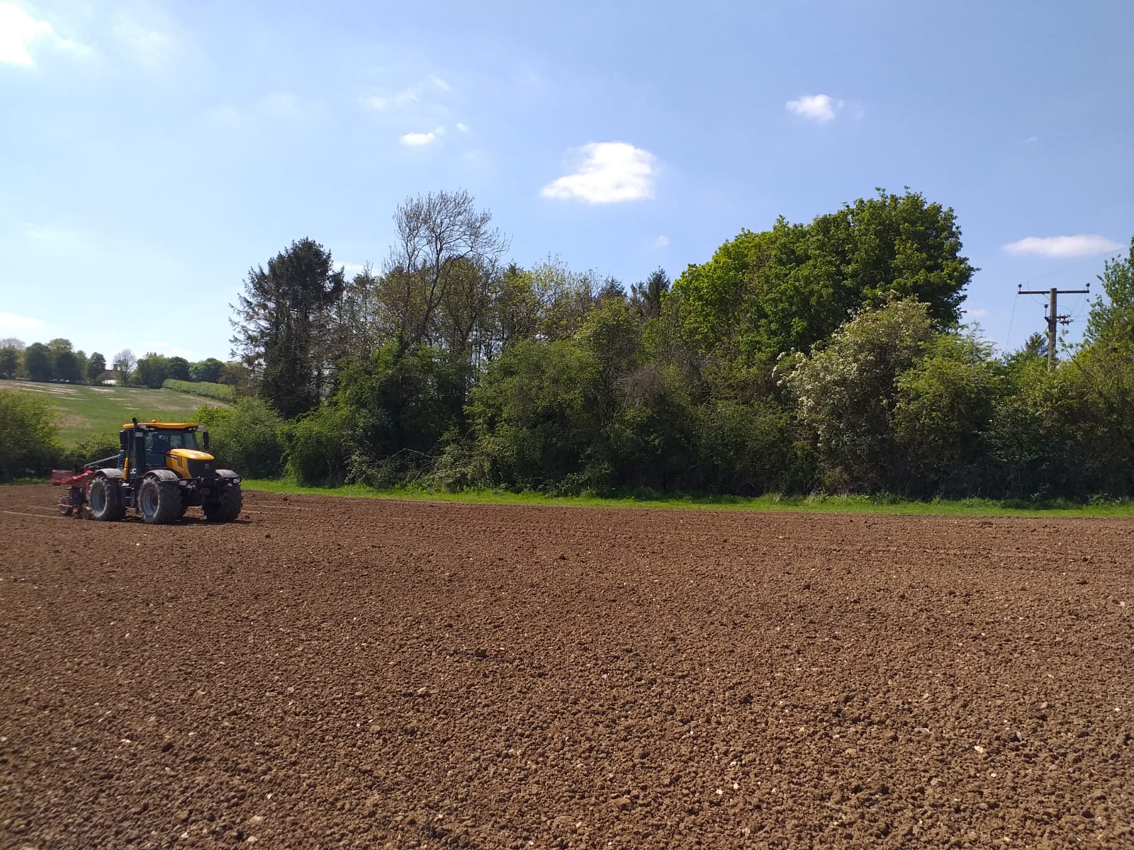 UK vineyarde being planted with a planting machine. 