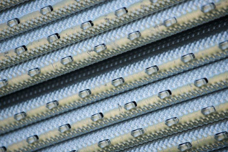 Close up of metal vineyard trellising posts in a bundle.